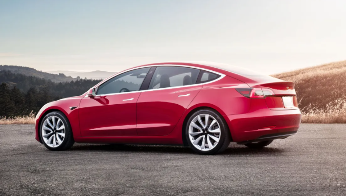2025 Tesla Model 3 Performance and Long Range parked side by side at sunset