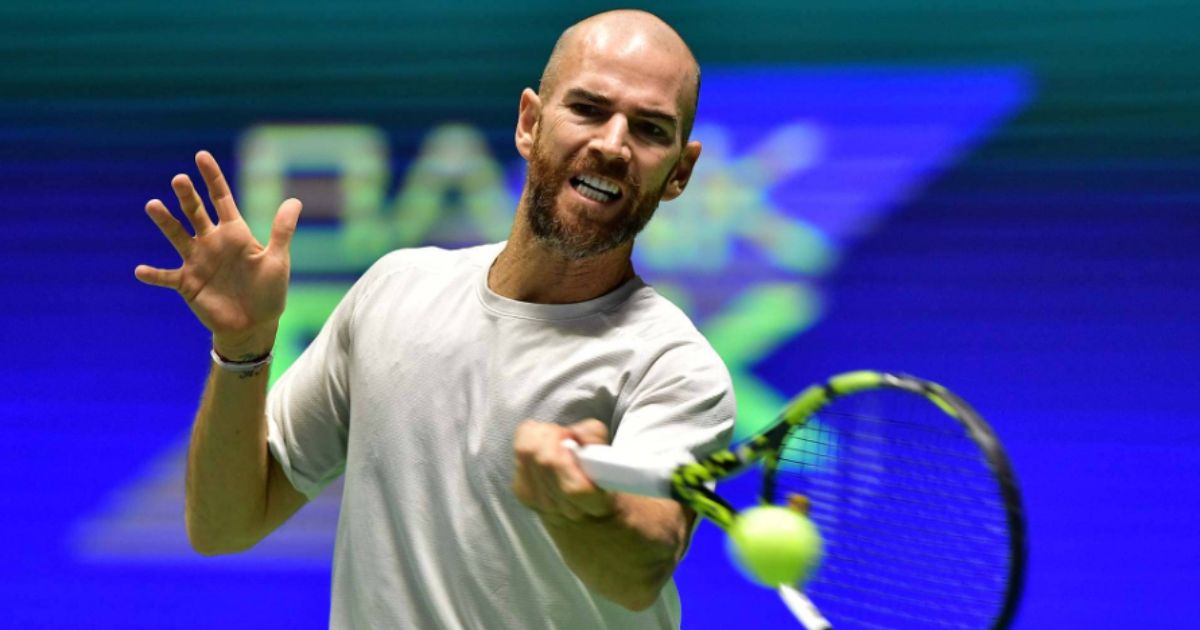 Adrian Mannarino hitting a forehand on grass during Wimbledon 2025