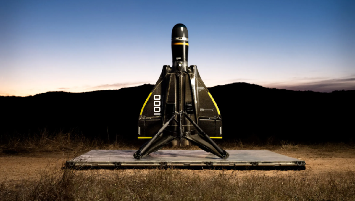 Anduril Industries’ Pulsar electronic warfare unit on a tripod at dusk, with a drone swarm in the distance