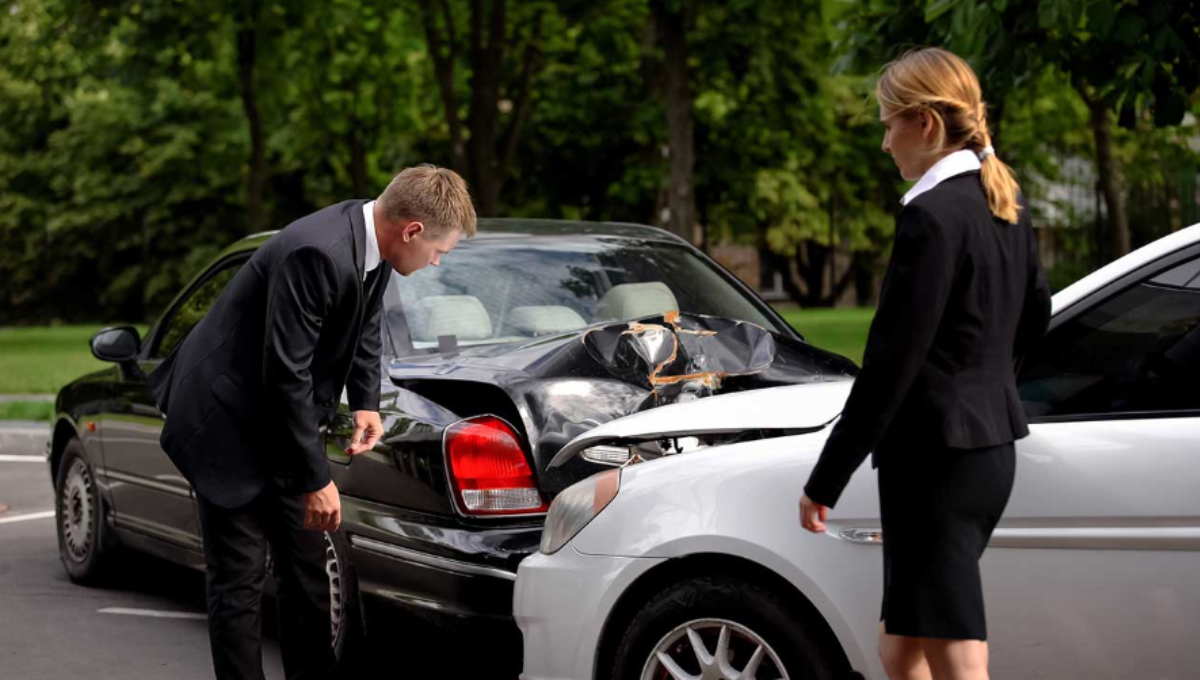  Auto accident attorney reviewing a crash scene photo and medical bills at a desk