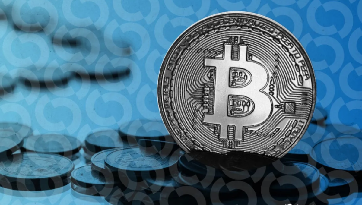 Bitcoin price chart on a laptop with red candlesticks during an intraday drop