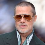 Brad Pitt on the red carpet in 2025, backdrop with his name