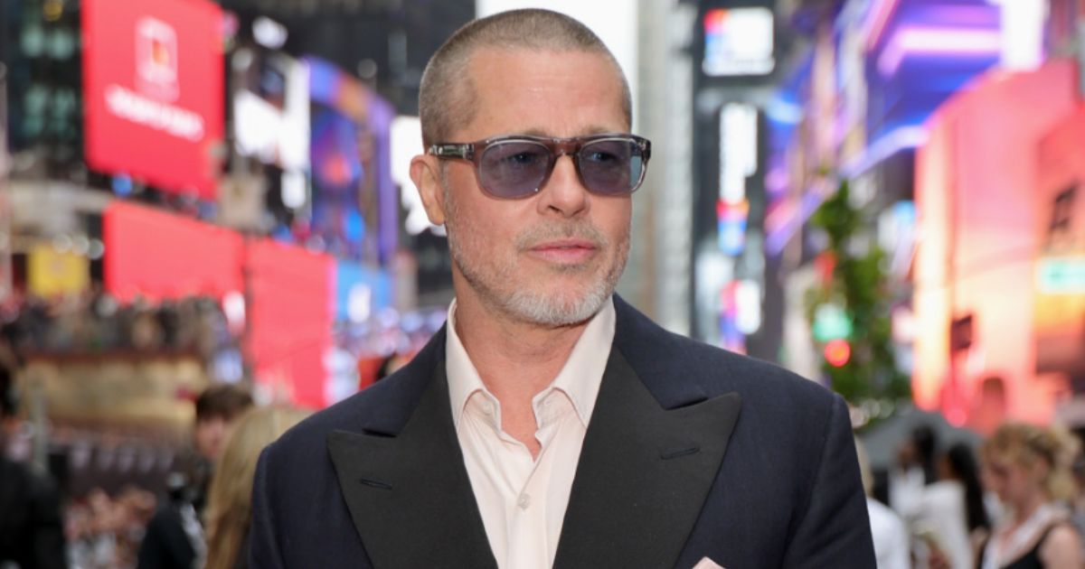 Brad Pitt on the red carpet in 2025, backdrop with his name