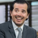 John Leguizamo speaking at a cultural event in 2025