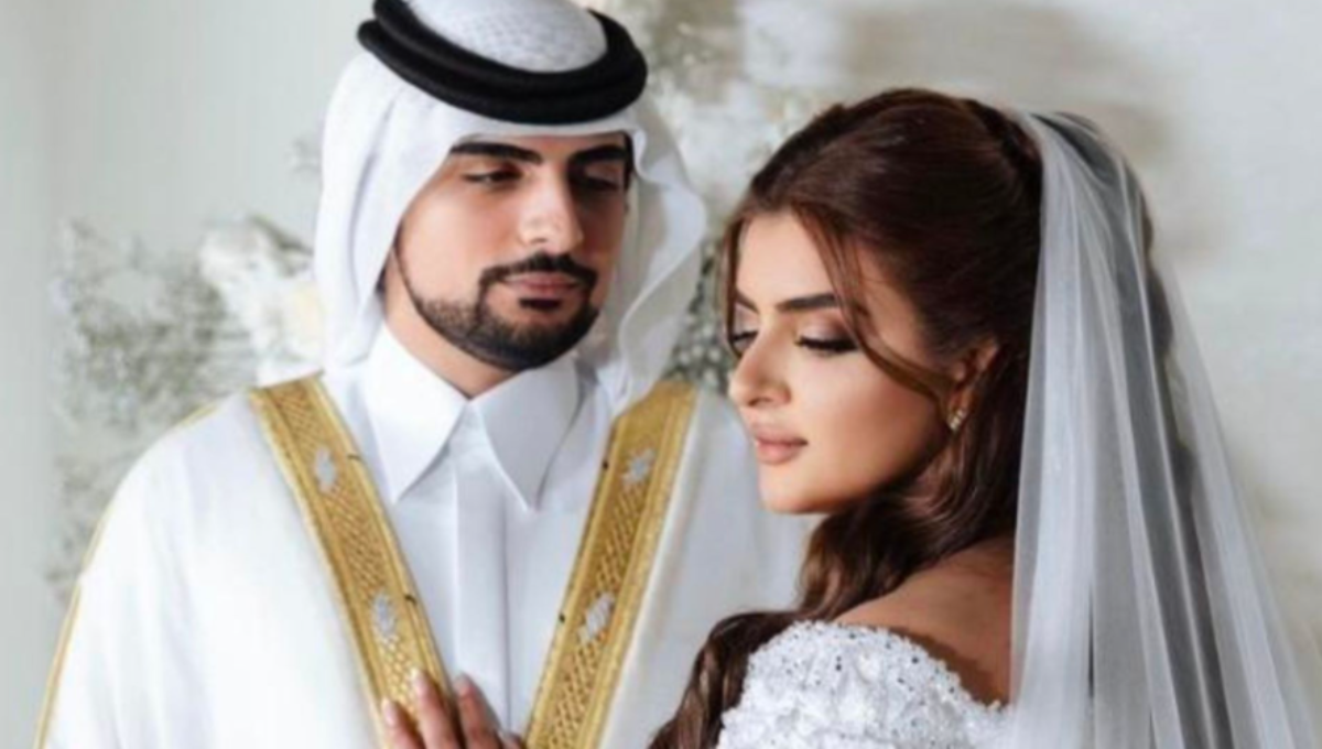 Sheikha Mahra at a fashion event, photographed in a gold-toned dress with a soft spotlight