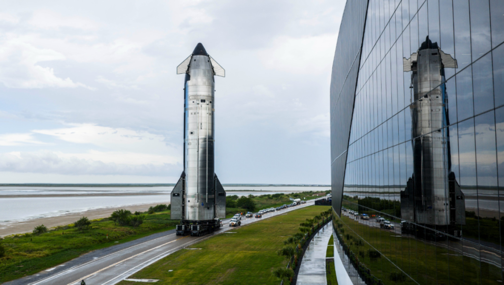 SpaceX Starship stacked on Super Heavy at Starbase during golden hour with venting vapors