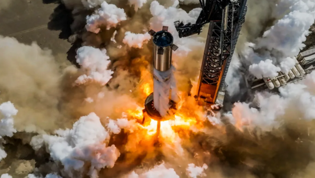 SpaceX Starship stacked on Super Heavy at Starbase at golden hour with vapor clouds