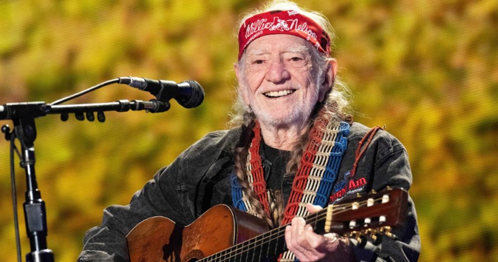 Willie Nelson performing live on stage with guitar Trigger during the Outlaw Music Festival 2025