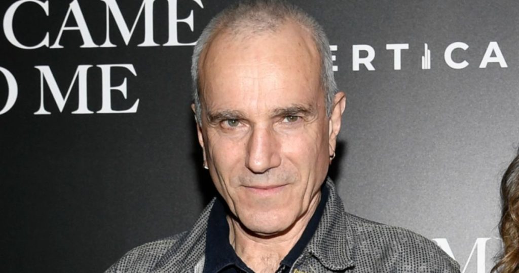 Daniel Day-Lewis smiling in a tuxedo at a red carpet event in 2025