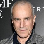 Daniel Day-Lewis smiling in a tuxedo at a red carpet event in 2025
