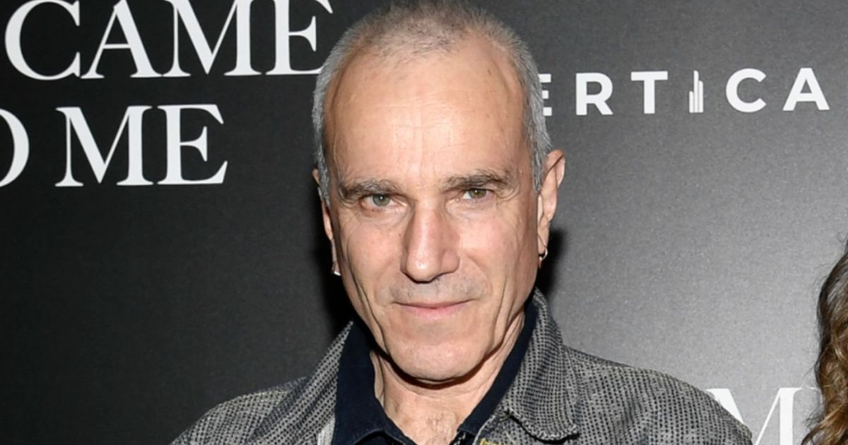 Daniel Day-Lewis smiling in a tuxedo at a red carpet event in 2025