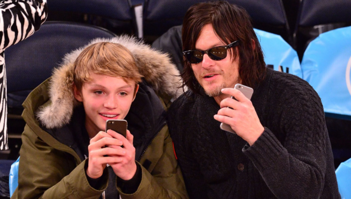 Mingus Lucien Reedus at a runway backstage area with cameras and lights