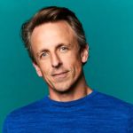 Seth Meyers performing behind his desk on Late Night, smiling in 2025