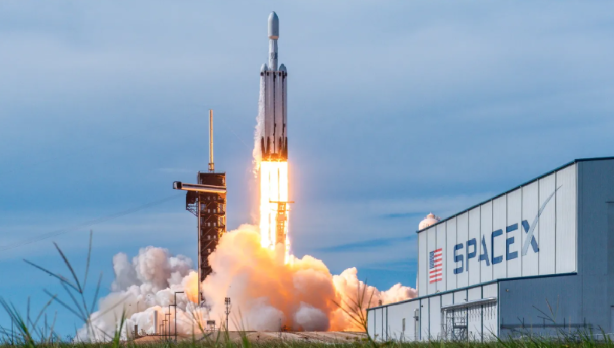 Falcon 9 lifting off at dusk with contrail and illuminated plume