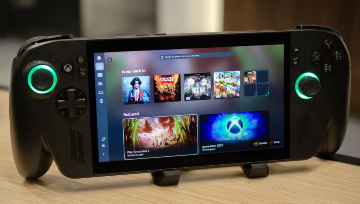 Xbox Ally X handheld on a desk showing the full-screen Xbox UI with Game Pass tiles