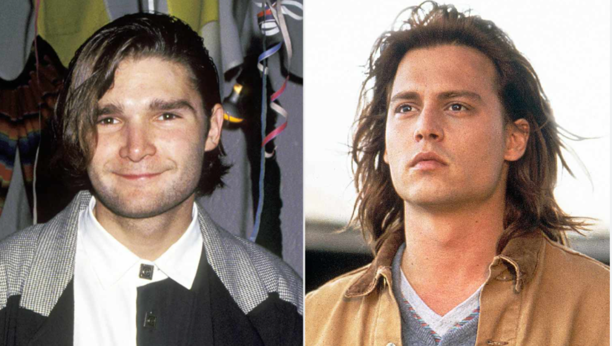 Corey Feldman performing on stage with spotlight and microphone