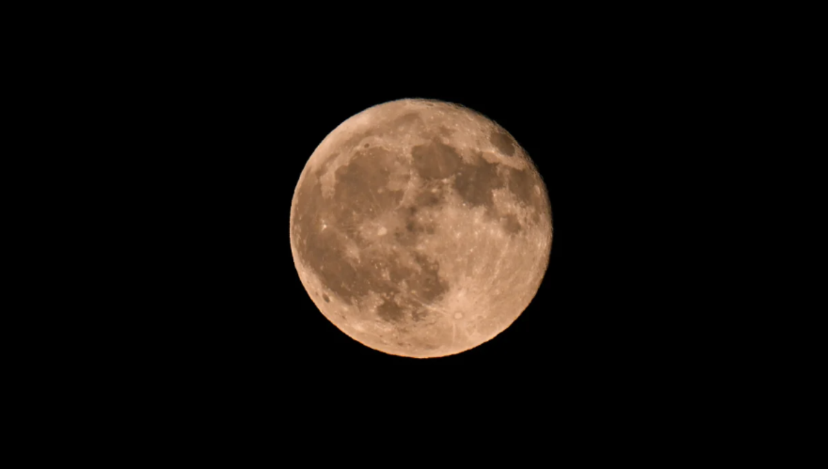 Full moon September 2025 total lunar eclipse over a night skyline