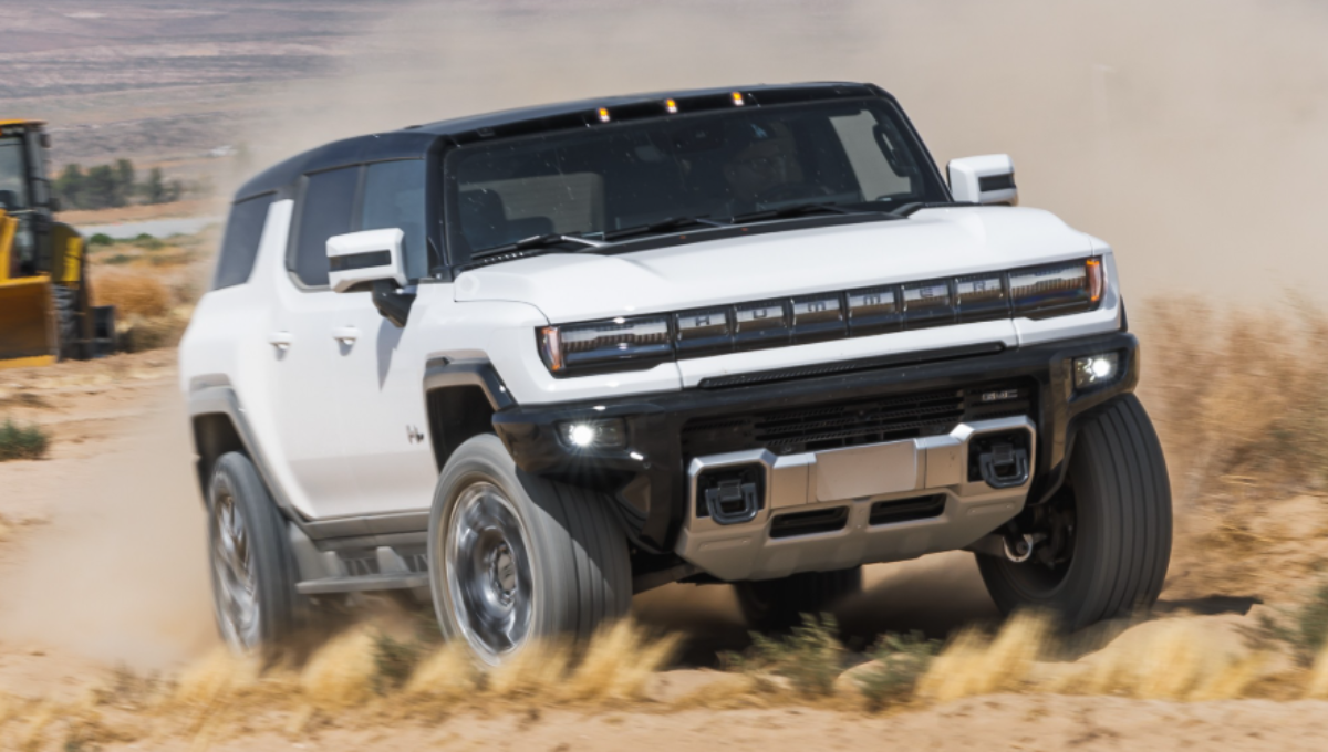 GMC Hummer EV 3X SUV in off-road terrain demonstrating CrabWalk with four-wheel steering at dusk