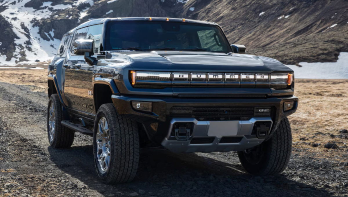GMC Hummer EV 3X SUV in off-road terrain demonstrating CrabWalk with four-wheel steering at dusk