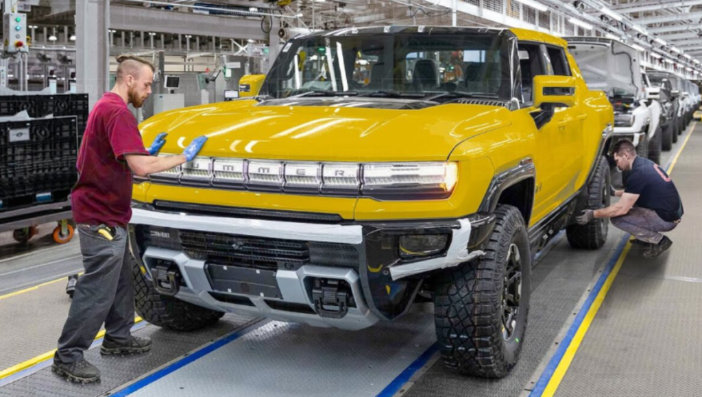 GMC Hummer EV 3X SUV in off-road terrain demonstrating CrabWalk with four-wheel steering at dusk