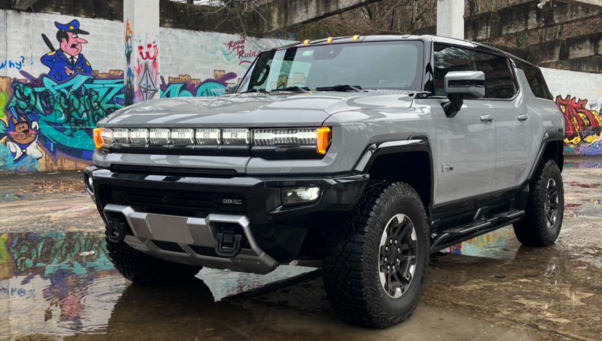 GMC Hummer EV 3X SUV in off-road terrain demonstrating CrabWalk with four-wheel steering at dusk