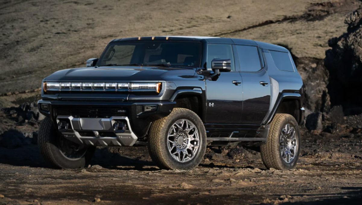 GMC Hummer EV 3X SUV in off-road terrain demonstrating CrabWalk with four-wheel steering at dusk