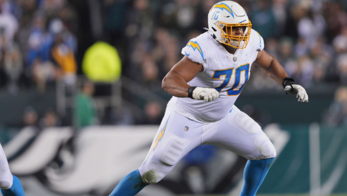 Rashawn Slater warming up on the sideline in Chargers uniform