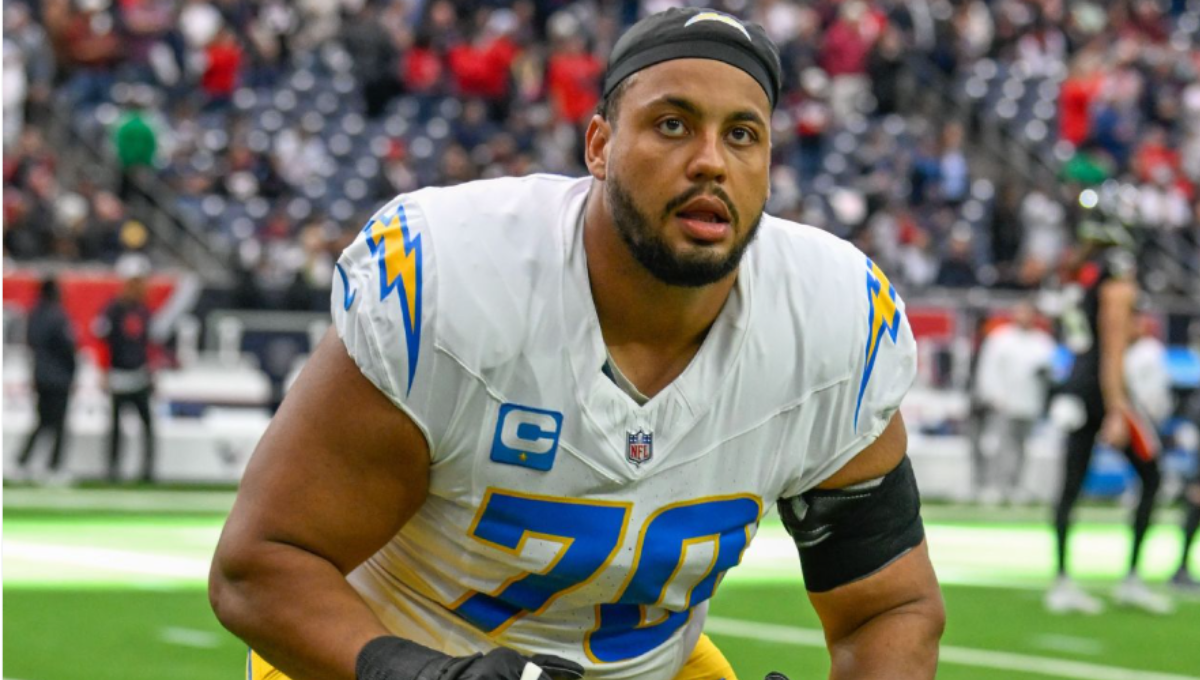 Rashawn Slater warming up on the sideline in Chargers uniform