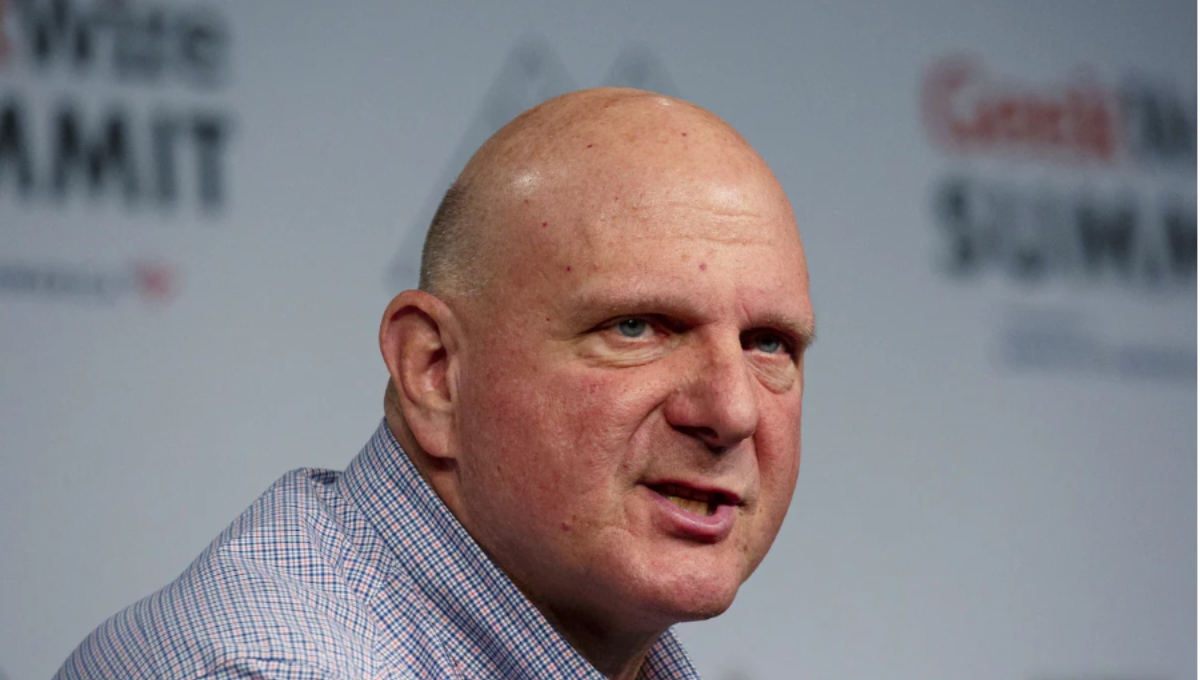 Steve Ballmer smiling courtside at Intuit Dome with fans in the background