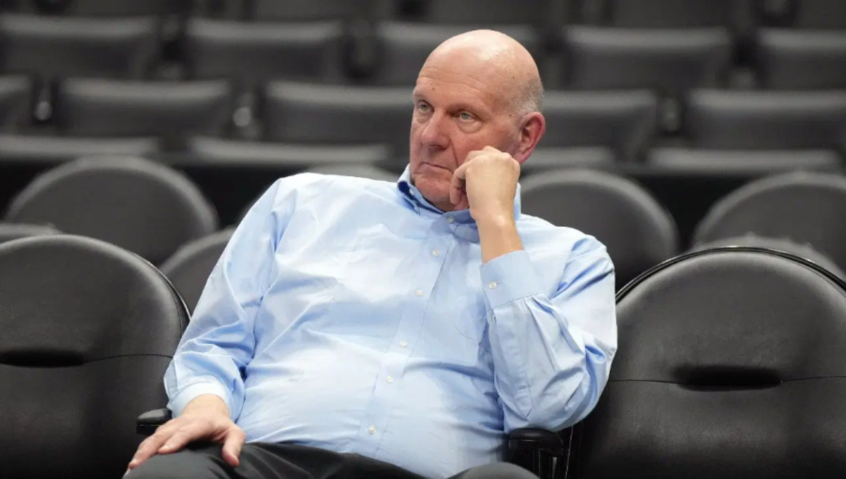 Steve Ballmer smiling courtside at Intuit Dome with fans in the background